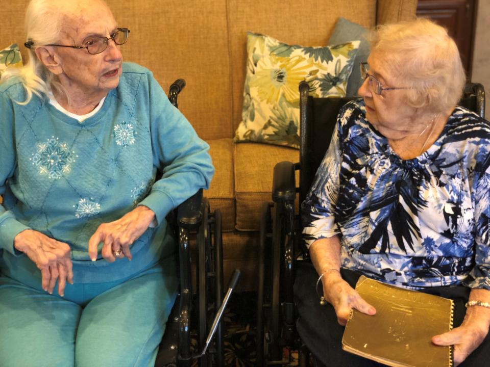 Jane Scott and Joann Vandiver talk before returning to their rooms at the assisted living home American House of Jackson on April 1, 2022.