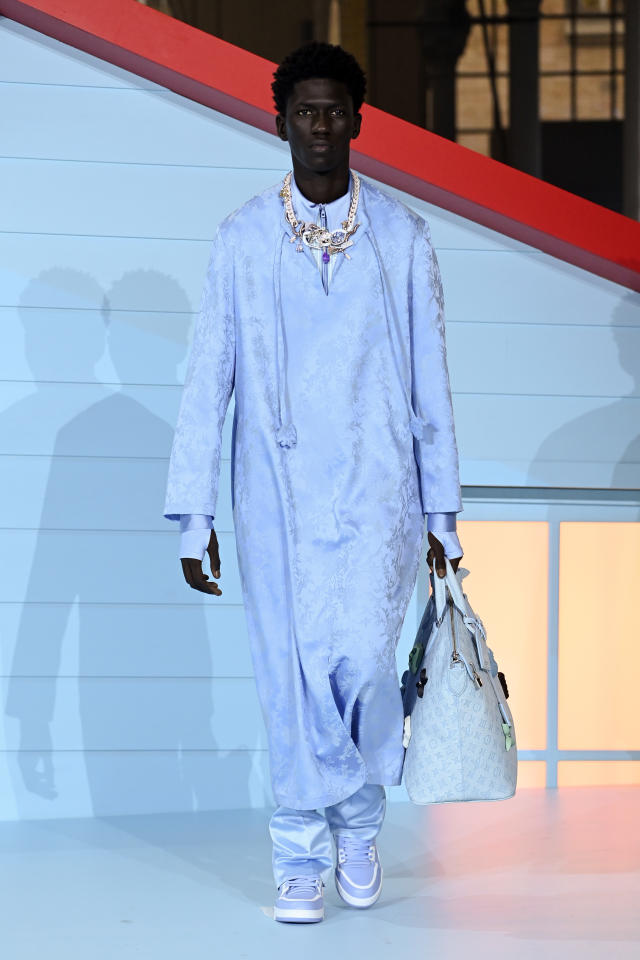 A model, bag detail, walks the runway during the Louis Vuitton