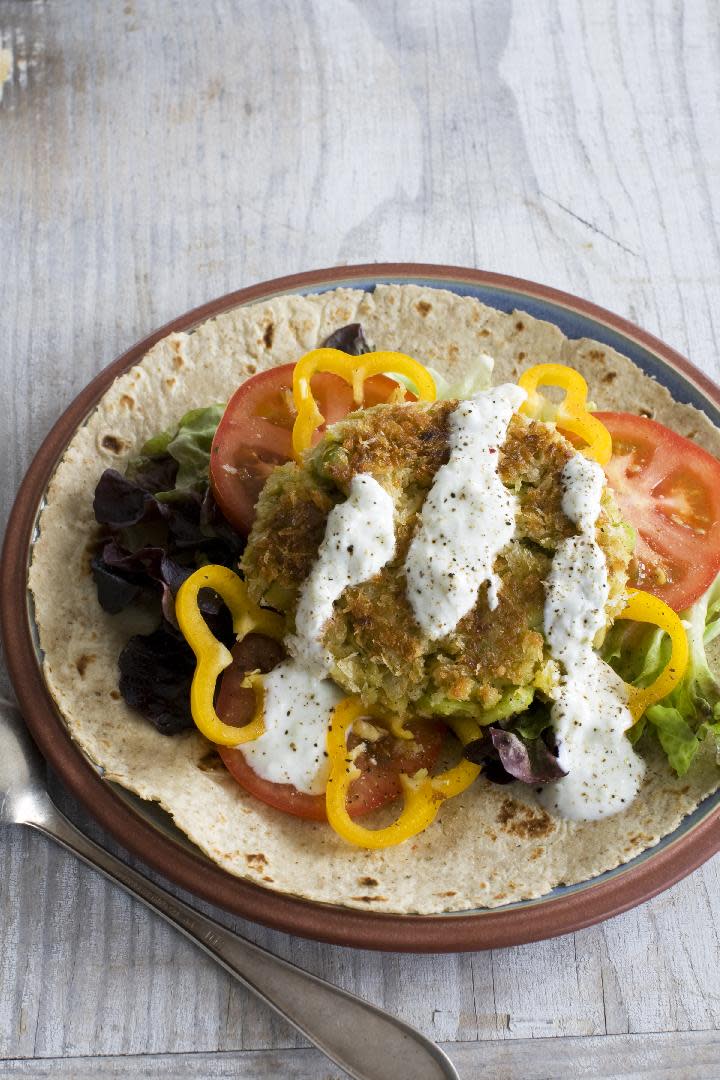 This March 25, 2013 photo taken in Concord, N.H., shows a recipe for Fava Bean Falafel Burger topped with a cucumber yogurt sauce. Falafel are deep-fried fritters made from ground chickpeas or fava beans. (AP Photo/Matthew Mead)