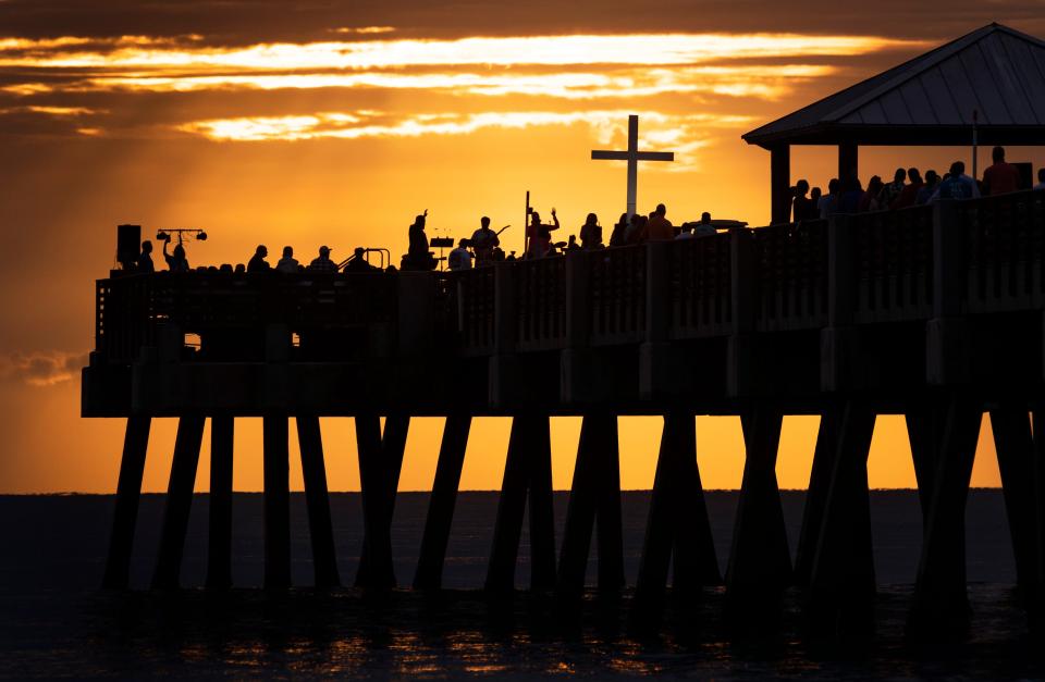 Worshipers gather on the Juno Beach Pier for an Easter sunrise service led by Holy Spirit Lutheran Church on April 9, 2023 in Juno Beach, Florida.