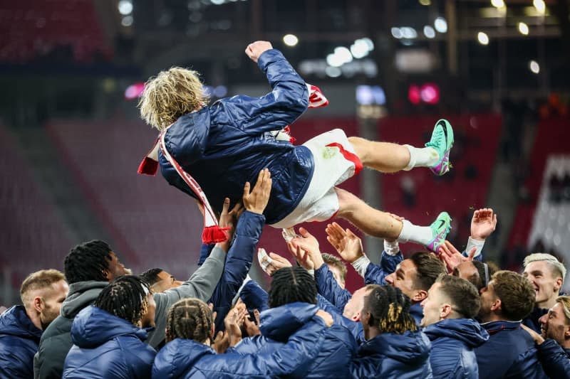 Leipzig's Emil Forsberg is thrown into the air by the team after the German Bundesliga soccer match between RB Leipzig and TSG 1899 Hoffenheim at the Red Bull Arena.  It was Forsberg's last home game in Leipzig. Jan Woitas/dpa