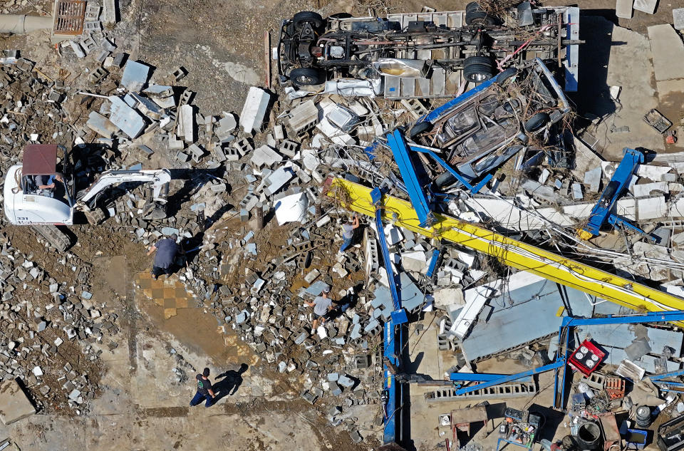 An aerial view of people clearing away debris in the aftermath of Hurricane Helene in Asheville, North Carolina.