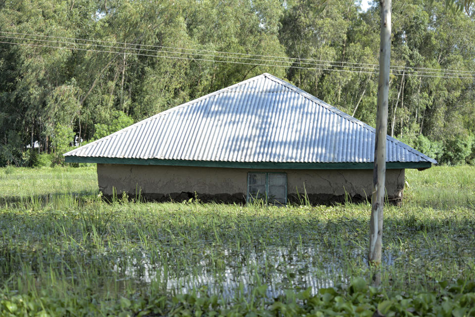 A partially submerged house is seen in a residential area in Kisumu, Kenya Wednesday, April 17, 2024. Heavy rains pounding different parts of Kenya have led to the deaths of at least 13 people and displaced some 15,000, the United Nations said, as forecasters warned more rains can be expected until June. (AP Photo/Brian Ongoro)