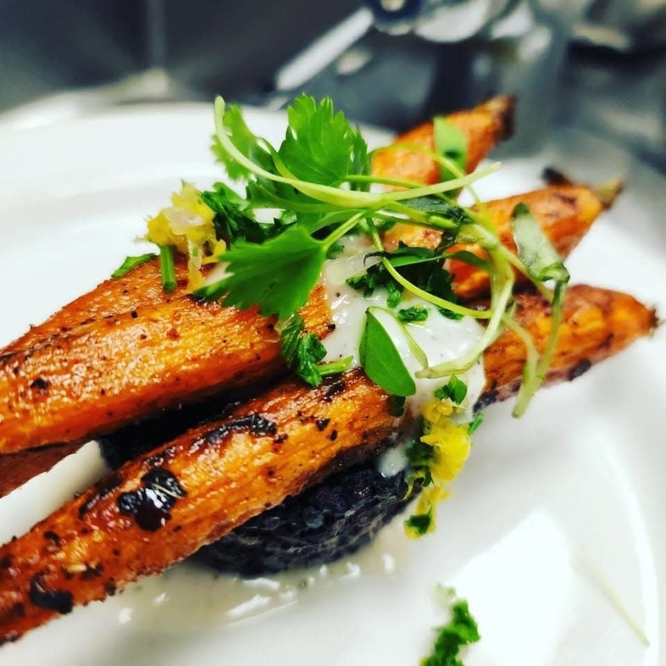 Harissa carrots on a bed of black rice with a lemon garlic sauce, a dish created by Lansing resident and chef Kari Magee. Magee is partnering with Shawn Elliott to open Veg Head, a vegan restaurant, in downtown Lansing.