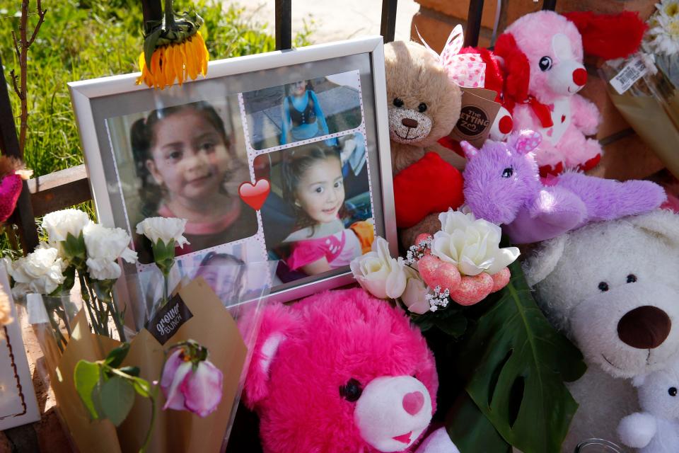 A memorial of photos, flowers and stuffed animals on Feb. 9, 2020, grows outside a home where skeletal remains of a girl were found in Phoenix. The remains of Ana Loera, aka Charisma Marquez, were discovered wrapped in a bedsheet in the attic after a fire in January 2020.