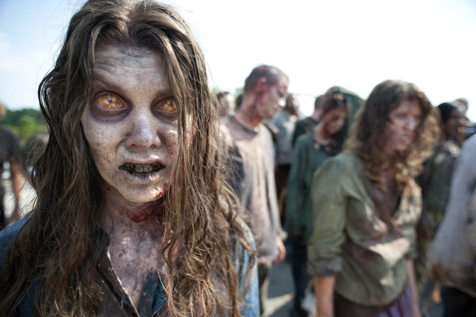 In this image released by AMC, zombies appear in a scene from the second season of the AMC original series, "The Walking Dead," in Senoia, Ga. The series’ fourth season premieres on Oct. 13. Crews have been filming the new episodes in Georgia, but they keep locations of future episodes closely-guarded secrets until the shows air. In Grantville, Ga., the town’s ruins were featured prominently last season. In nearby Senoia, many scenes are filmed in the historic downtown area, transforming into the fictional town of Woodbury for the show. (AP Photo/AMC, Gene Page) NO SALES