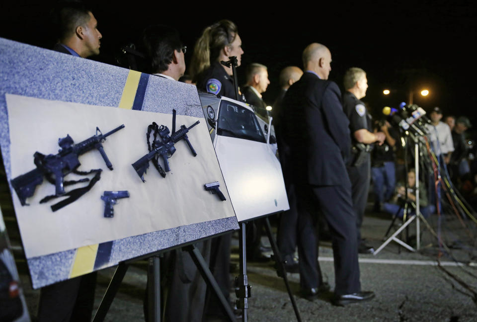 FILE - Police crime photos of assault rifles and handguns are displayed during a news conference near the site of a mass shooting in San Bernardino, Calif., on Dec. 3, 2015. A federal judge who previously overturned California's three-decade-old ban on assault weapons did it again on Thursday, Oct. 19, 2023, ruling that the state's attempts to prohibit sales of semiautomatic guns violates the constitutional right to bear arms. (AP Photo/Chris Carlson, File)