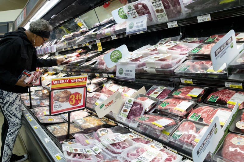 A Safeway customer looks at meat products at a supermarket, a subsidiary of Albertsons, in Washington, D.C., in 2022. The Federal Trade Commission is suing to stop the proposed $24.6 billion acquisition of Albertson's Companies by The Kroger Company, according to court documents filed Monday. File Photo by Michael Reynolds/EPA-EFE