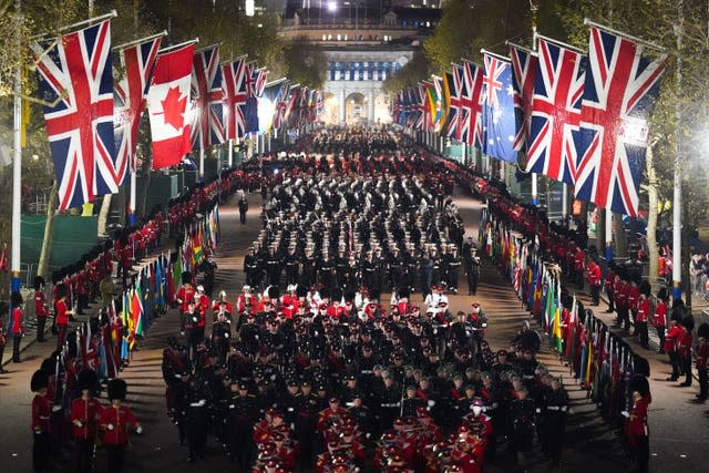 Lines of uniformed soldiers and a mixture of union flags and other international flags visible on the Mall during the rehearsal.