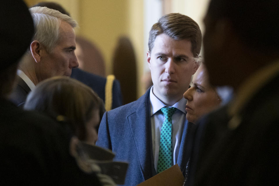 FILE - In this March 5, 2019, photo, Sen. Rob Portman, R-Ohio, left, talks with Homeland Security Secretary Kirstjen Nielsen, right, and her chief of staff Miles Taylor depart after the Republican Caucus luncheon on Capitol Hill in Washington. Taylor who penned a scathing anti-Trump op-ed and book under the pen name "Anonymous" made his identify public, Oct. 28, 2020. (AP Photo/Alex Brandon)