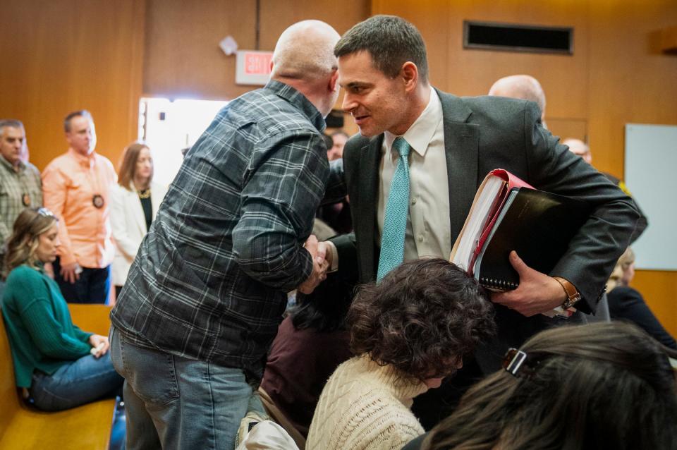 Craig Shilling, left, father of Justin Shilling, who was killed in the Oxford School shooting in 2021, shakes hands with Oakland County Assistant Prosecutor Mark Keast after Jennifer Crumbley, mother of shooter Ethan Crumbley, was found guilty on four counts of involuntary manslaughter in the Oakland County courtroom of Cheryl Matthews on Tuesday, Feb. 6, 2024.