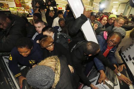 Shoppers compete to purchase retail items on "Black Friday" at an Asda superstore in Wembley, north London November 28, 2014. REUTERS/Luke MacGregor