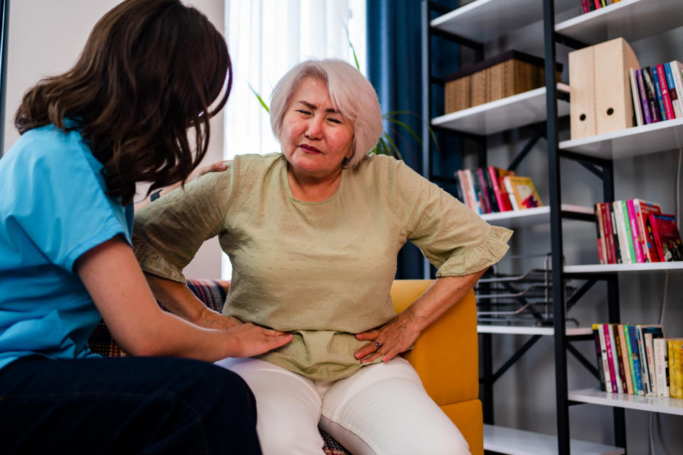 Abdominal pain patient woman having medical exam with doctor on illness from stomach cancer, irritable bowel syndrome, pelvic discomfort, Indigestion, Diarrhea, GERD (gastro-esophageal reflux disease)