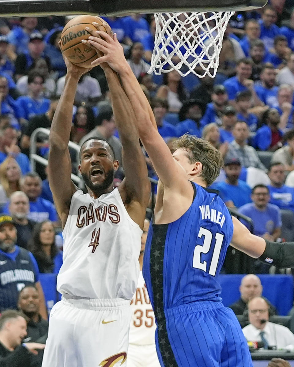 Cleveland Cavaliers forward Evan Mobley (4) is fouled by Orlando Magic center Moritz Wagner (21) while attempting a shot during the first half of Game 4 of an NBA basketball first-round playoff series, Saturday, April 27, 2024, in Orlando, Fla. (AP Photo/John Raoux)