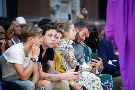 David Beckham and his children Brooklyn, Romeo, Cruz and Harper attend the Victoria Beckham catwalk show at London Fashion Week in London