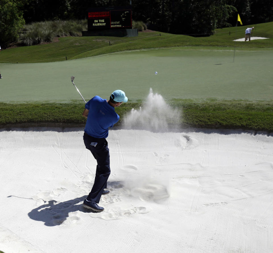 Matt Kuchar hits from the sand onto the eighth green during a practice round for The Players championship golf tournament at TPC Sawgrass in Ponte Vedra Beach, Fla., Wednesday, May 7, 2014. (AP Photo/Gerald Herbert)