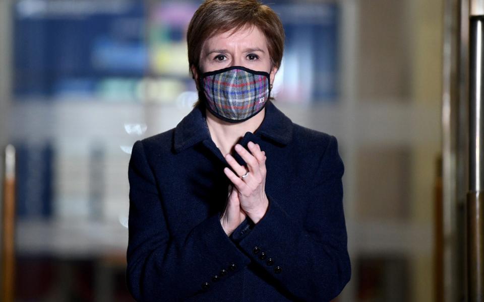 Scotland's First Minister Nicola Sturgeon applauds outside St Andrews House during a national clap for late Captain Sir Tom Moore - Jeff J Mitchell/Pool/Reuters