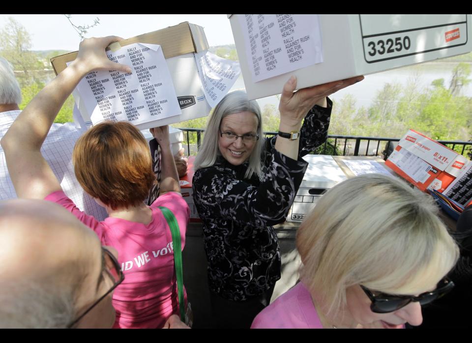 Protesters carry boxes containing petition signatures Wednesday, March 28, 2012, in Jefferson City, Mo. The protesters delivered 35,000 petition signatures Wednesday to the House speaker's office opposing the inclusion of conservative talk show host Rush Limbaugh in the Hall of Famous Missourians in the latest in a series of opposition efforts to Limbaugh's selection. (AP Photo/Jeff Roberson)