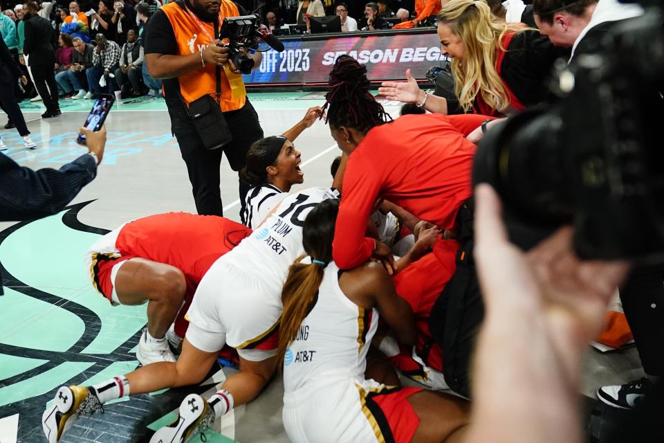 Las Vegas Aces' Sydney Colson, left, and head coach Becky Hammon, right, celebrate with teammates after Game 4 of a WNBA basketball final playoff series against the New York Liberty Wednesday, Oct. 18, 2023, in New York. The Aces won 70-69. (AP Photo/Frank Franklin II)