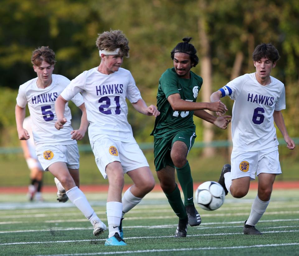 Spackenkill's Jeet Shahani fends off Rhinebeck's, from left, Lindon Stout and Ian Binnie during Monday's game in the Town of Poughkeepsie on September 13, 2021.