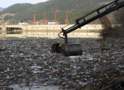 Plastic bottles, wooden planks, rusty barrels and other garbage clogging the Drina river near the eastern Bosnian town of Visegrad, Bosnia, Tuesday, Jan. 5, 2021. Further upstream, the Drina tributaries in Montenegro, Serbia and Bosnia are carrying even more waste after the swollen rivers surged over the the landfills by their banks. The Balkan nations have poor waste management and tons of garbage routinely end up in rivers. (AP Photo/Eldar Emric)