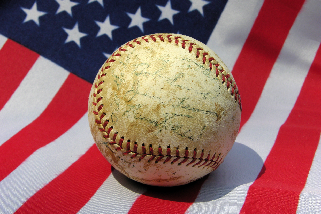 Autographed baseball on an American flag background