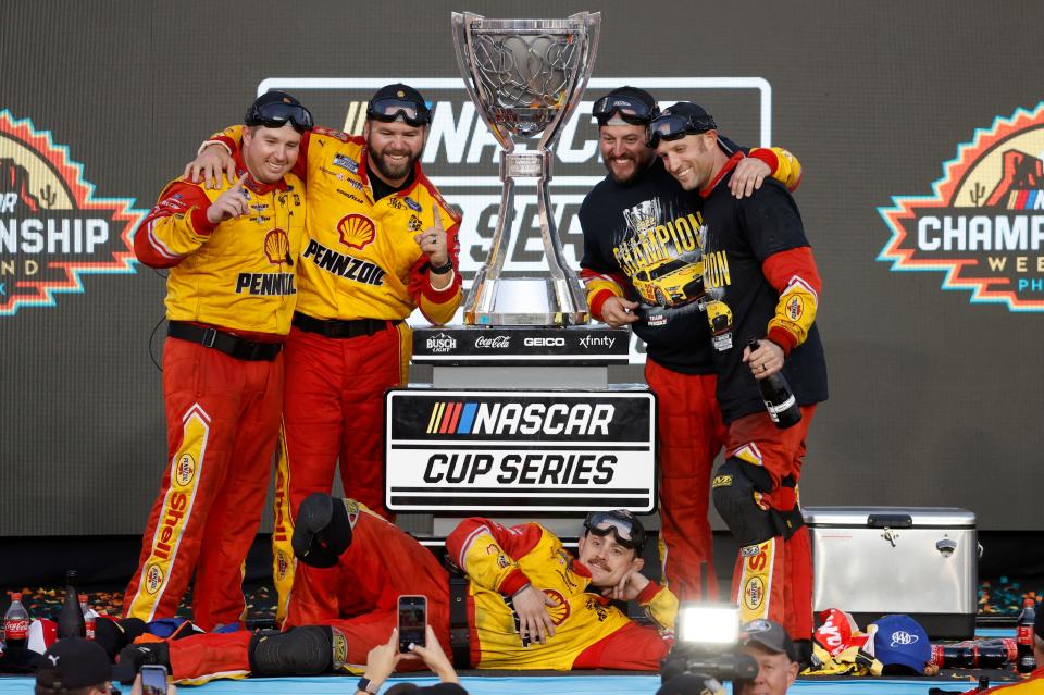 Asheville native Nick Hensley, to right of the trophy, poses with his fellow pit crew members after his team for Joey Logano won the 2022 NASCAR Cup Series championship.