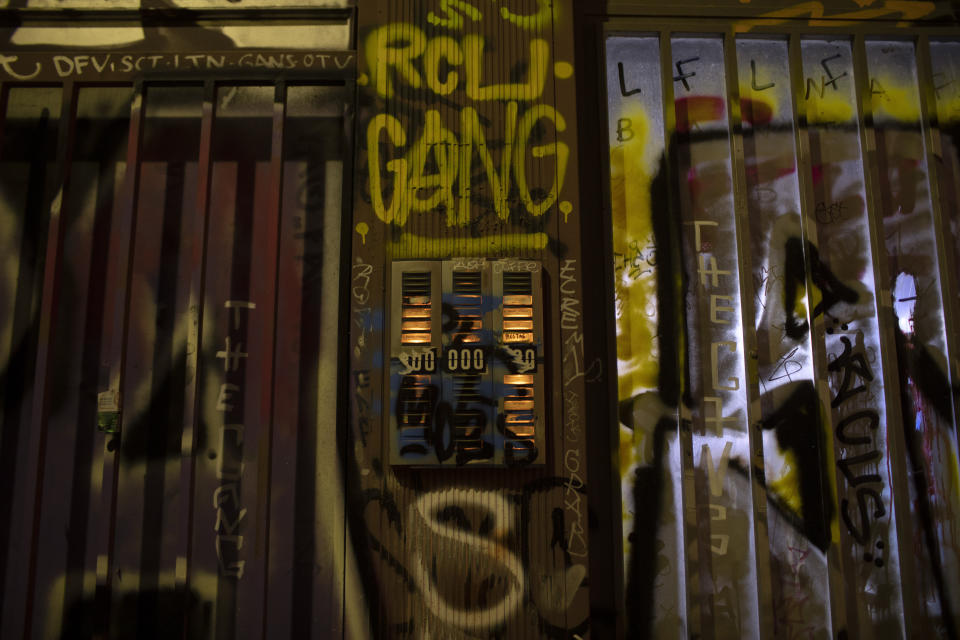 In this Saturday, July. 6, 2019, the doorbells of a building are covered with graffiti in Psiri district, central Athens. (AP Photo/Petros Giannakouris)