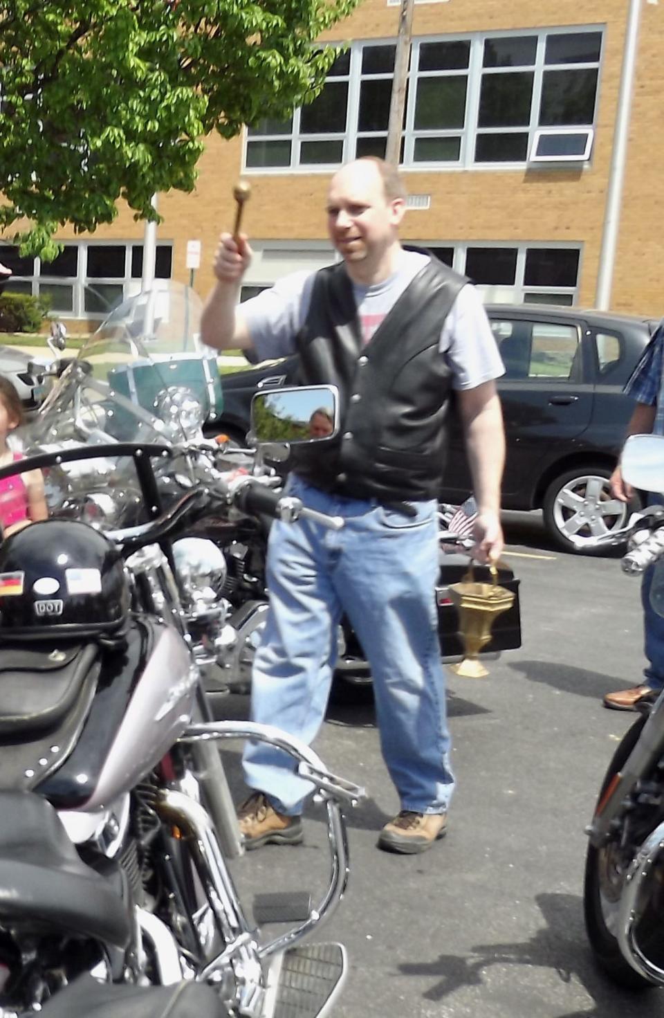 The Rev. Michael Zacharias blesses motorcycles in June 2014 outside St. Joseph Catholic Church in Fremont. After the blessing, the riders, including Father Mike, took off on their bikes for about an hour ride.