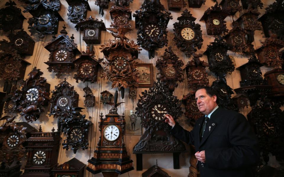 Horologist Roman Piekarski adjusting the antique clocks at Cuckooland Museum in Tabley - Credit: Lynne Cameron/PA Wire