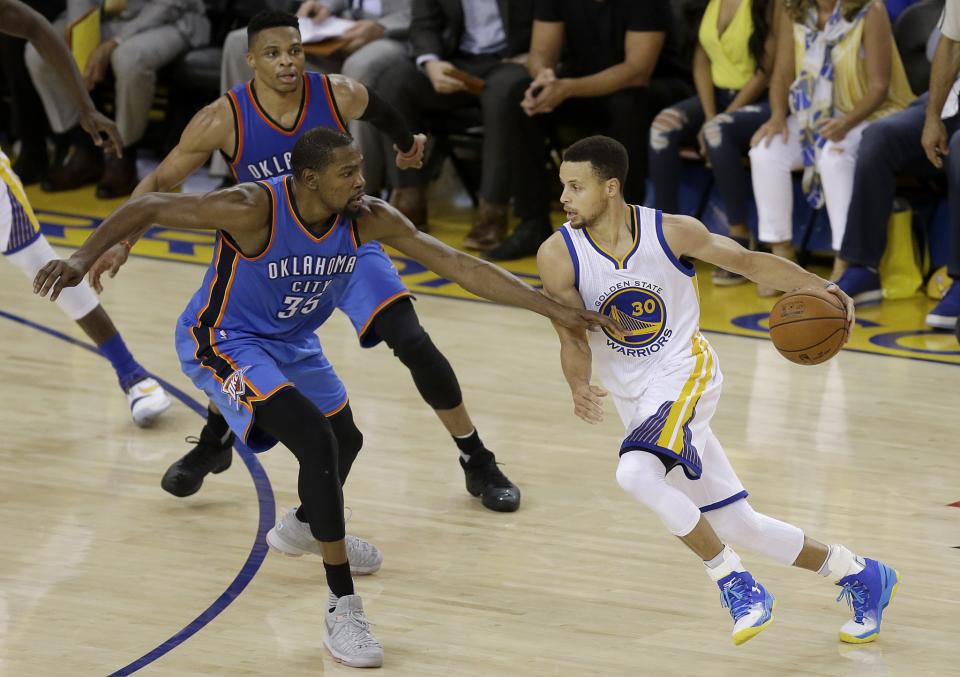 The next time these three players share the court, Stephen Curry and Kevin Durant will be the ones wearing the same jersey. (AP/Ben Margot)