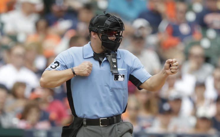 Home plate umpire Will Little signals during the seventh inning of a baseball game between the Detroit Tigers and the Chicago White Sox, Wednesday, Aug. 31, 2016, in Detroit. (AP Photo/Carlos Osorio)