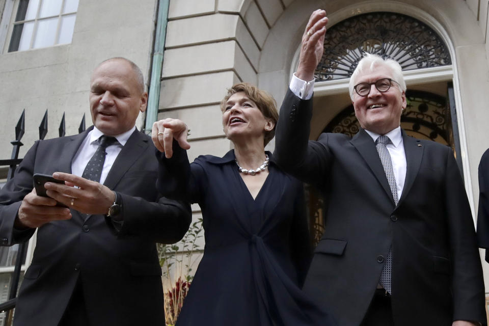 German President Frank-Walter Steinmeier, right, poses for a photo with his wife, Elke Budenbender, and Goethe Institute Secretary General Johannes Ebert on the steps of the Goethe Institute, Thursday, Oct. 31, 2019, in Boston. (AP Photo/Elise Amendola)