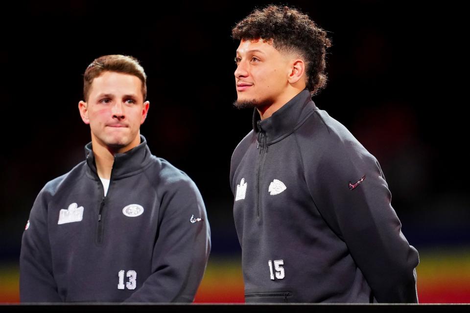 Brock Purdy of the San Francisco 49ers (L) and Patrick Mahomes of the Kansas City Chiefs stand on stage during Super Bowl LVIII Opening Night at Allegiant Stadium on February 05, 2024 in Las Vegas, Nevada.