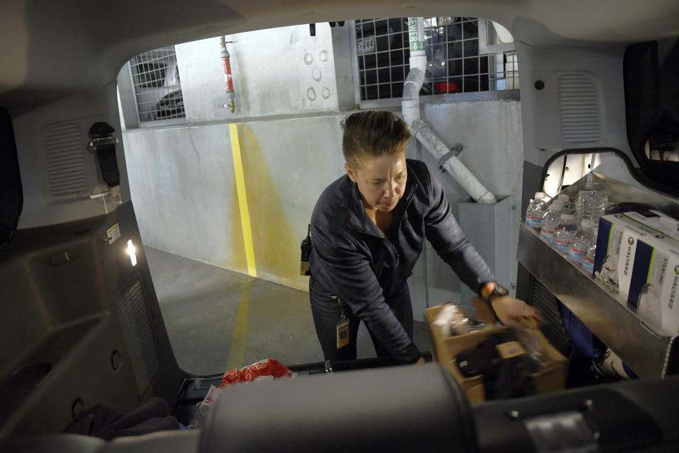 WellPower clinician Jane Lemaux loads supplies into a STAR van in Denver on Thursday, Oct. 20, 2022. The STAR program uses clinicians and EMTs or paramedics to respond to nonviolent mental health crises, instead of police. Data gathered by The Associated Press show at least 14 of the 20 most populous U.S. cities are hosting or starting such programs, sometimes called civilian, alternative or non-police response teams. They span from New York and Los Angeles to Columbus, Ohio, and Houston, and boast annual budgets that together topped $123 million as of June 2023, the AP found. (AP Photo/Thomas Peipert)