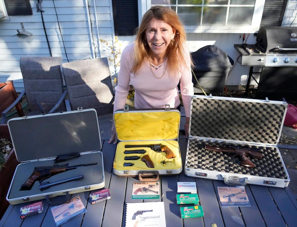 Gun owner Christine Joyce Brown shows an assortment of her guns she uses at shooting ranges while at her home in Milwaukee on Wednesday, Nov. 15, 2023.