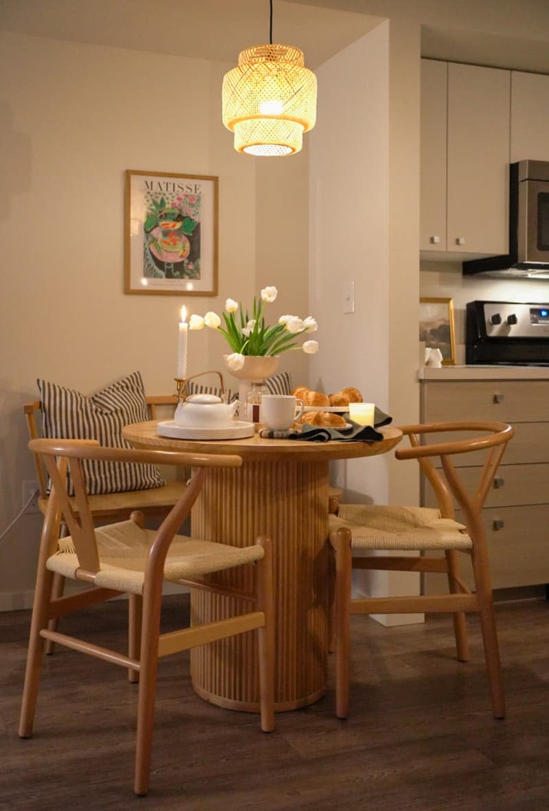 Coffee table with decorative items below a ceiling lamp.