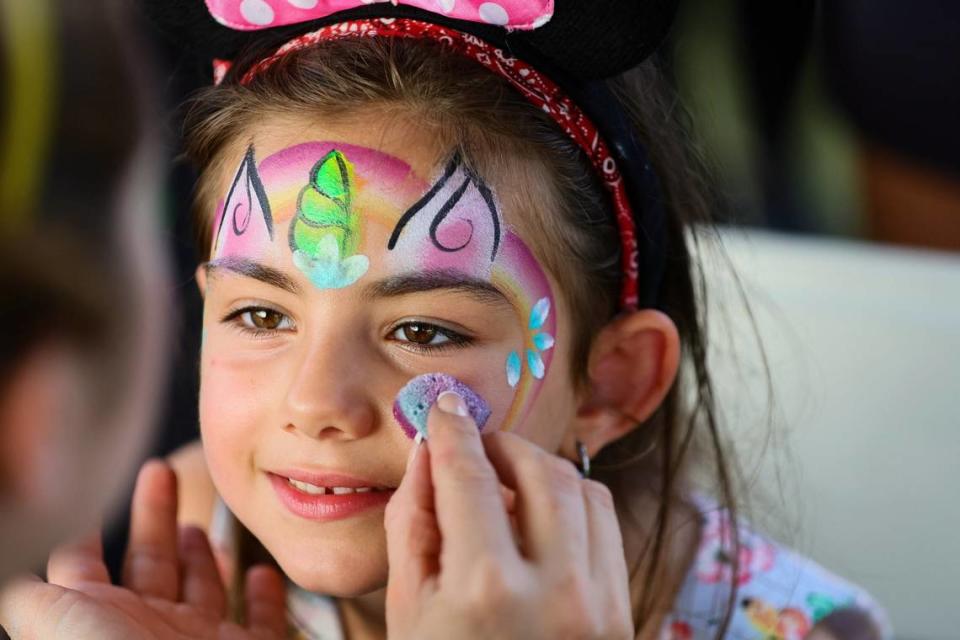 Teresa Ghanj, 5, stays still as artist Ahrid Hannaley works on a unicorn face during the inauguration of the eastern portion of Doral Central Park at 3005 NW 92nd Ave. in Doral, Florida, on Monday, Aug. 26, 2024.