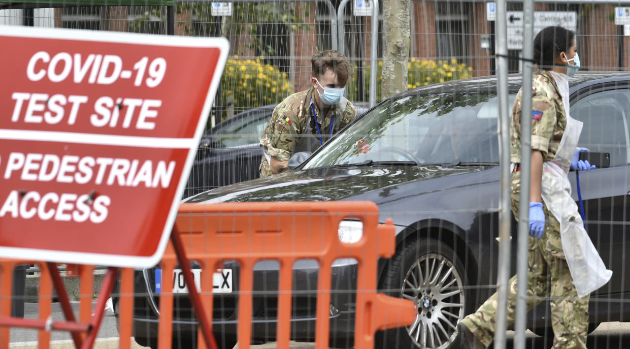 Members of the army work at a coronavirus testing station set up in Victoria Park in Leicester, England, Tuesday June 30, 2020. The British government has reimposed lockdown restrictions in the English city of Leicester after a spike in coronavirus infections, including the closure of shops that don't sell essential goods and schools. (AP Photo/Rui Vieira)