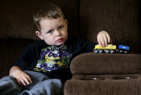 Joshua Sekerak plays with his train at his home in Leetonia, Ohio, United States on May 21, 2016. REUTERS/Aaron Josefczyk