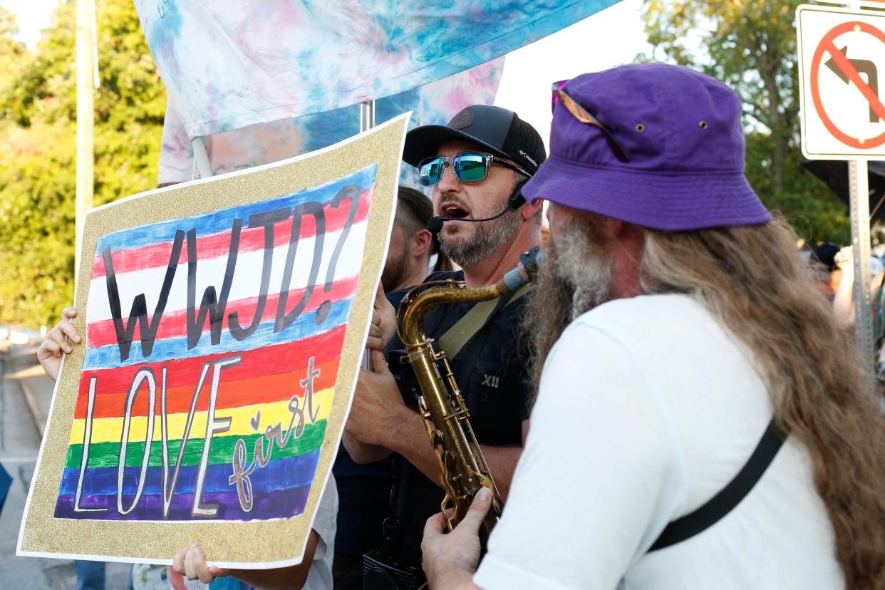 Protesters against the Athens Pride and Queer Collective's Athens Pride Week Kids and Youth Night Drag Story Hour are blocked by counter-protesters from the APQC outside of Hendershot's Coffee as parents and children enter the venue in Athens, Ga., on Wednesday, Sept. 14, 2022.