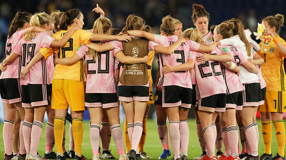 Players of Scotland huddle after their loss. (Photo by Daniela Porcelli/Getty Images)