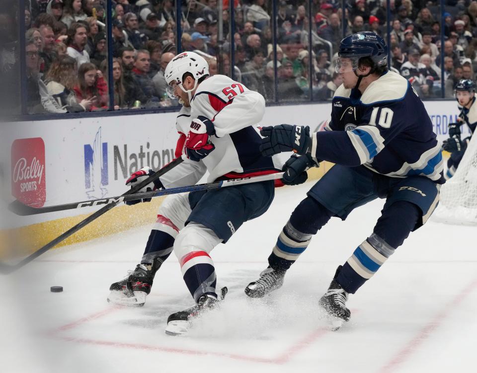 Dec. 201, 2023; Columbus, Ohio, USA; 
Washington Capitals defenseman Trevor van Riemsdyk (57) is defended by Columbus Blue Jackets left wing Dmitri Voronkov (10) during the first period of ThursdayÕs hockey game at Nationwide Arena.