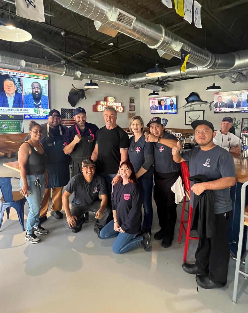 Sylvester Stallone poses with Pig Beach BBQ staff last week. The megastar had dropped by the Dixie Corridor restaurant for lunch with a few friends on Thursday, Feb. 1.