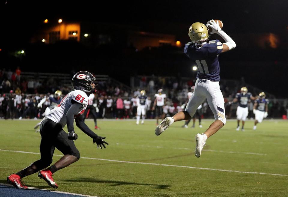 Hoban defensive back Elbert Hill IV, right, picks off a pass intended for Glenville wide receiver Donald Overby on Oct. 6 in Akron.