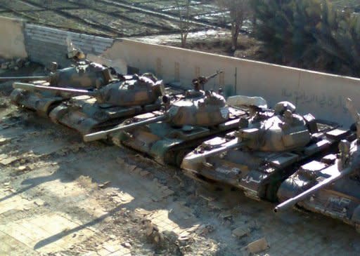 A handout picture released by Shaam News Network purportedly shows Syrian army tanks hidden inside a schoolyard before the arrival of the UN monitors to the city of Deir al-Zor. Syrian troops killed 28 civilians in the central city of Hama, monitors said, as UN military observers toured protest centres near the capital and both the European Union and the United States imposed new sanctions