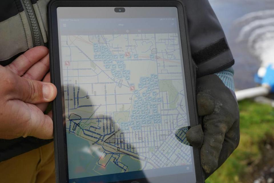 City utility worker Tyler Rouse holds a map on Tuesday, April 4, that shows hydrants in the Columbia neighborhood of Bellingham. The city began its annual water main flushing on Monday, April 3.
