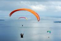 <p>Paragliders fly during the Paragliding Accuracy World Cup 1st Series 2017 at Mount Tumpa, Indonesia. </p>