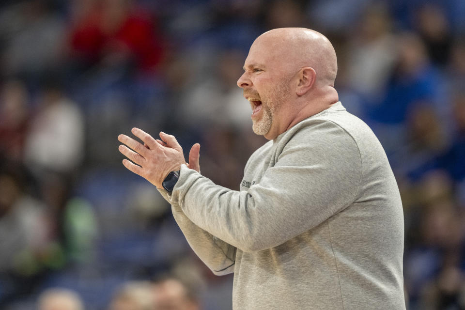 Indiana State coach Josh Schertz applauds during the first half of the team's NCAA college basketball game against Illinois State, Tuesday, Feb. 13, 2024, in Terre Haute, Ind. (AP Photo/Doug McSchooler)