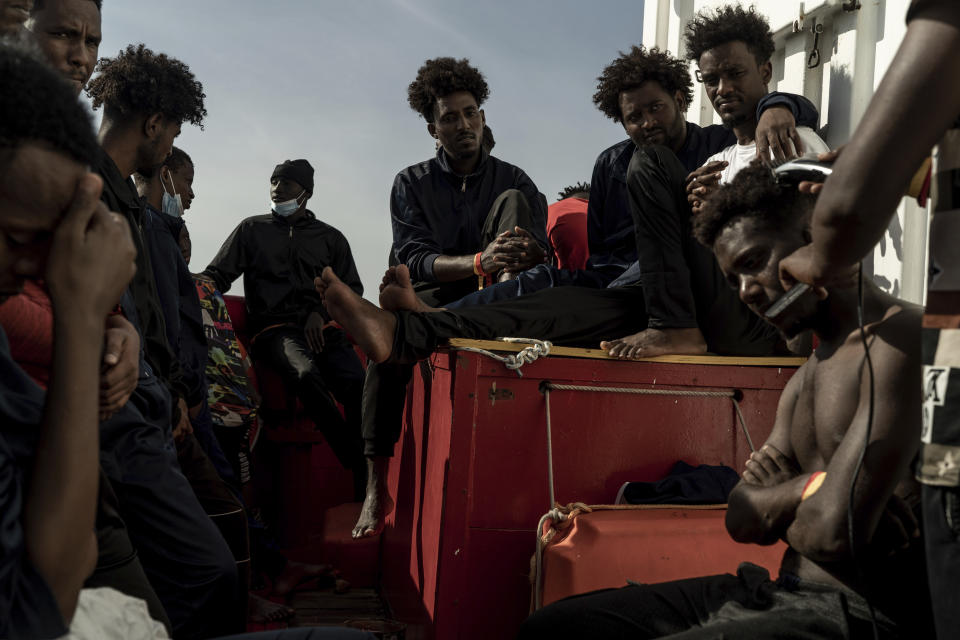 Some of the migrants rescued from the sea are seen on board of the humanitarian ship Ocean Viking cruising in the Mediterranean Sea, Wednesday, Nov. 9, 2022. The SOS Mediterranee humanitarian group said the Norwegian-flagged ship is heading toward the French island of Corsica in hopes that France will offer its 234 passengers a safe port, after Italy backed down and allowed migrants from three other rescue ships to disembark on Italian soil. (AP Photo/Vincenzo Circosta)